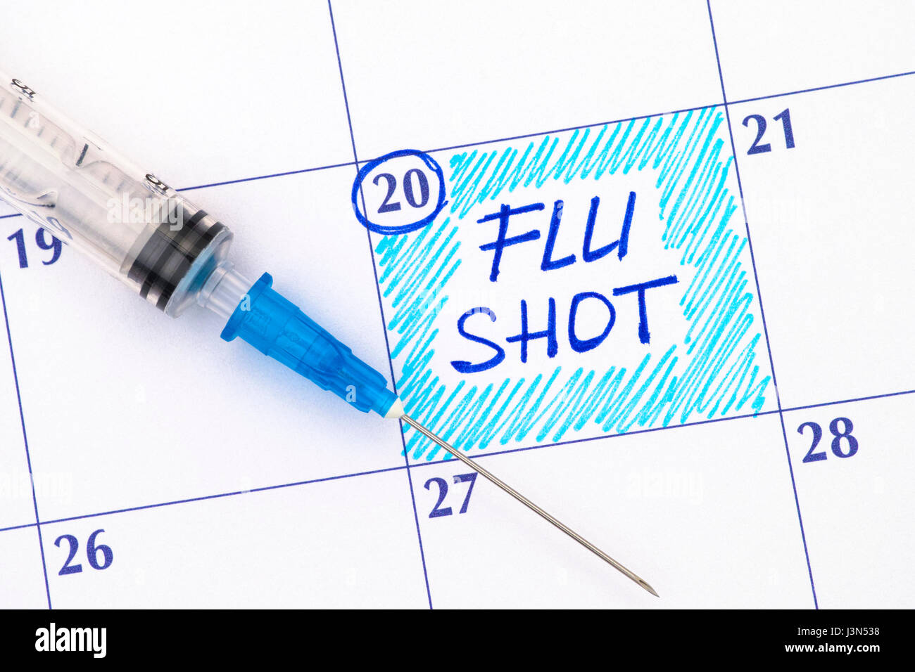 Injection Reminder Reminder Flu Shot in calendar with syringe. Close-up Stock Photo - Alamy