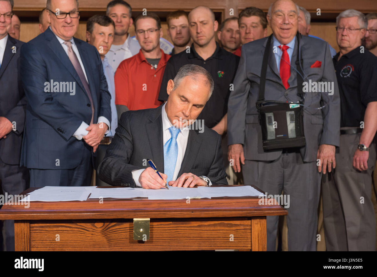 U.S. EPA Administrator Scott Pruitt, center, adds his signature to the Promoting Energy Independence Executive Order during a signing ceremony at the Environmental Protection Agency headquarters March 28, 2017 in Washington, DC. The order rolls back at least 10 major Obama environmental regulations and fulfills a wish list from the fossil fuel industry. Stock Photo