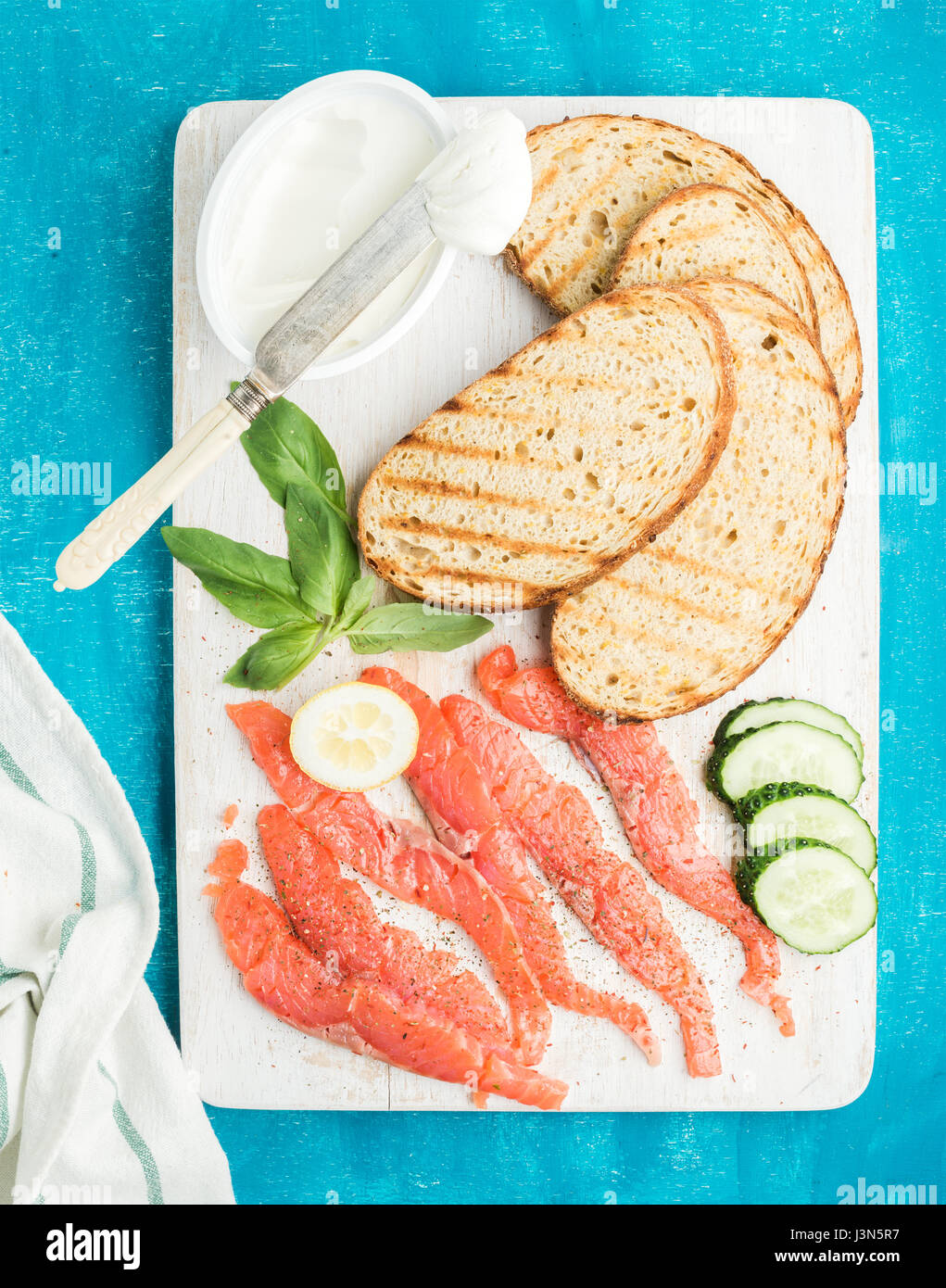 Ingredients for healthy sandwich. Grilled bread slices, smoked salmon