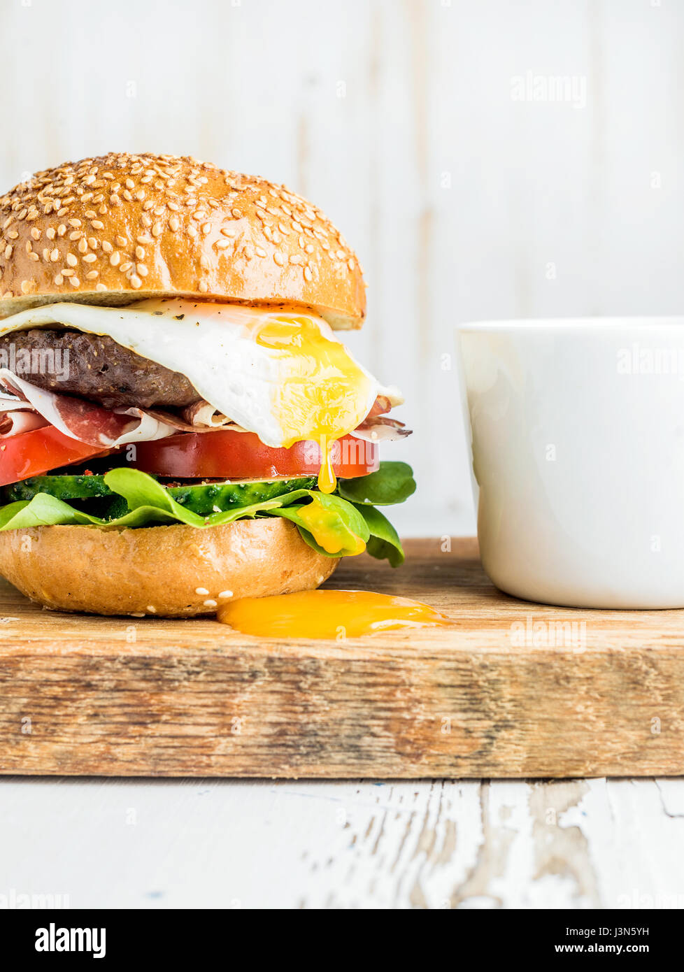 Breakfast set. Homemade beef burger with fried egg, vegetables, onion