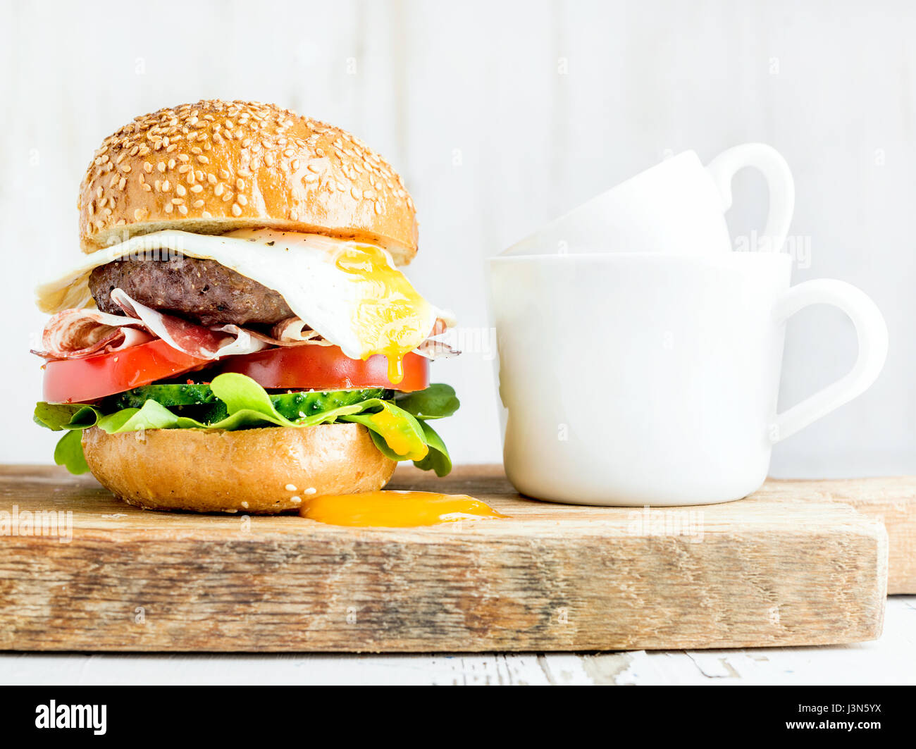 Breakfast set. Homemade beef burger with fried egg, vegetables, onion