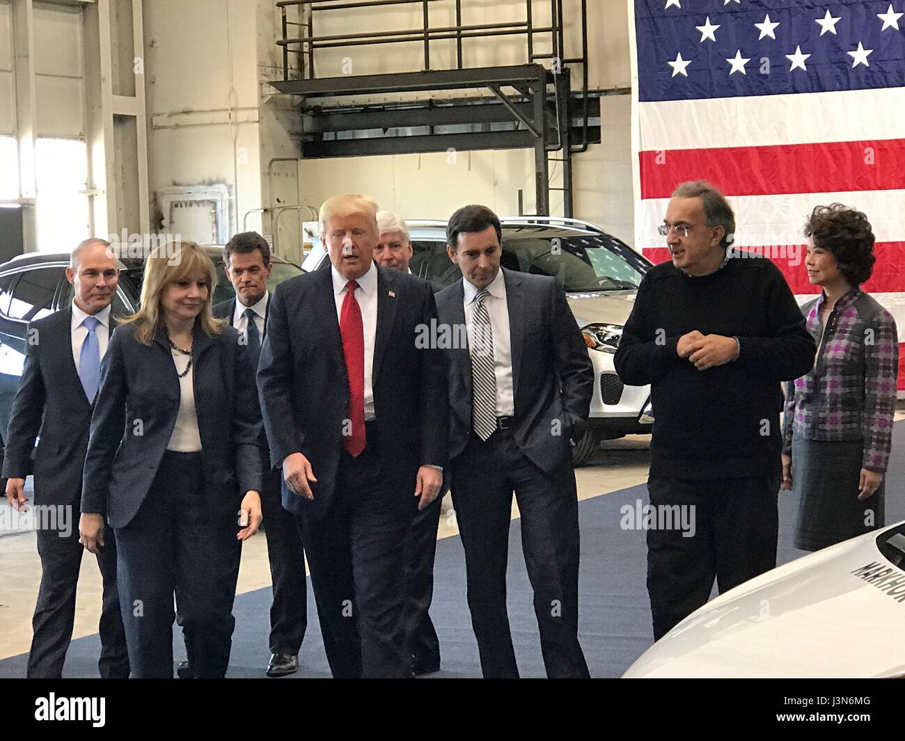 U.S. President Donald Trump views new car models during a tour of the American Center of Mobility March 15, 2017 in Ypsilanti Township, Michigan. From left are: EPA Administrator Scott Pruitt, GM CEO Mary Barra, Ford CEO Mark Fields, Fiat Chrysler CEO Sergio Marchionne and  Transportation Secretary Elaine Chao. Stock Photo