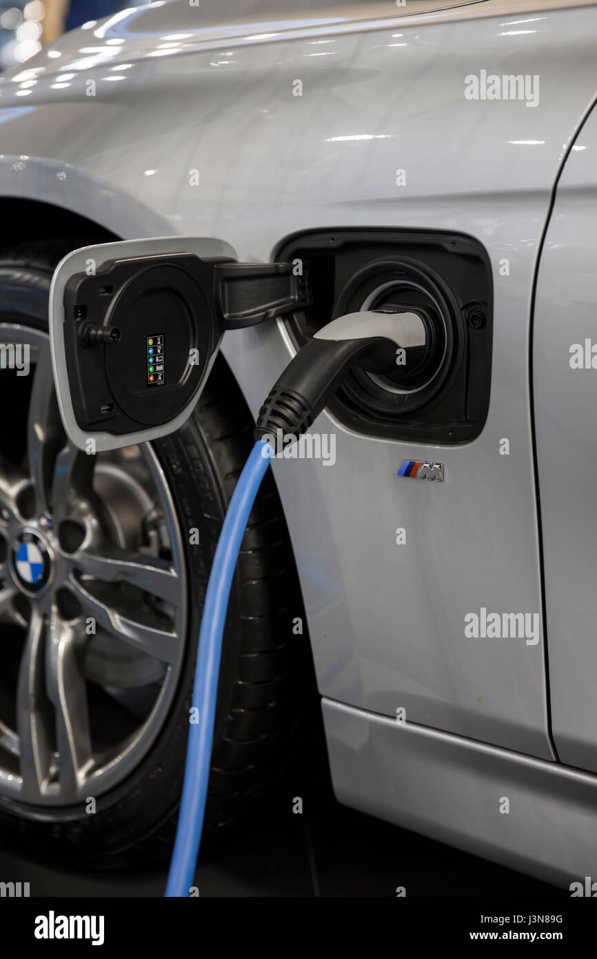 Recharging of hybrid BMW car. BMW ActiveHybrid technology unites a ...