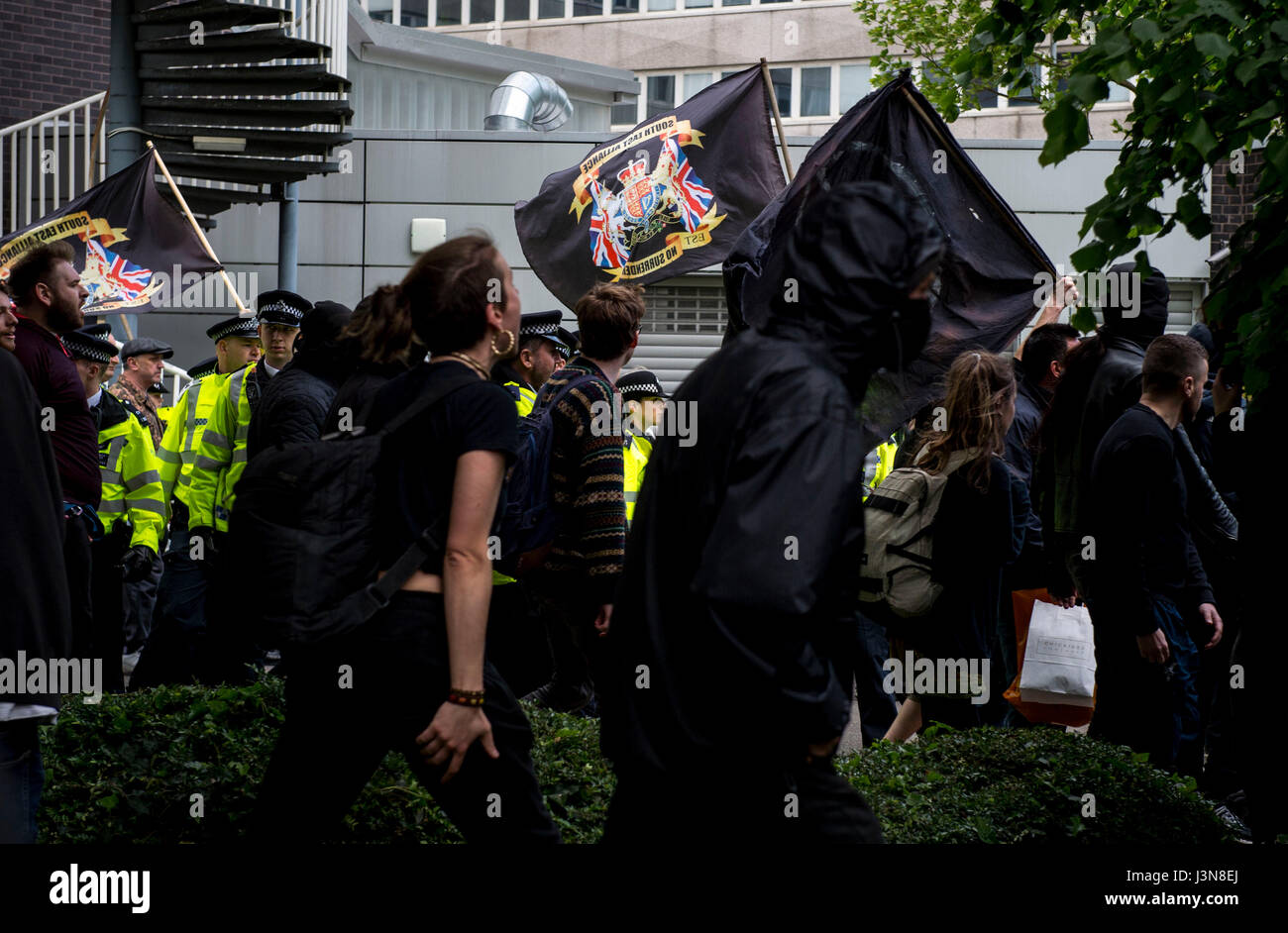 Police monitor two groups of protesters demonstrating for and against immigration outside Lunar House in Croydon, the headquarters of the Home Office's UK Visas and Immigration division. Stock Photo