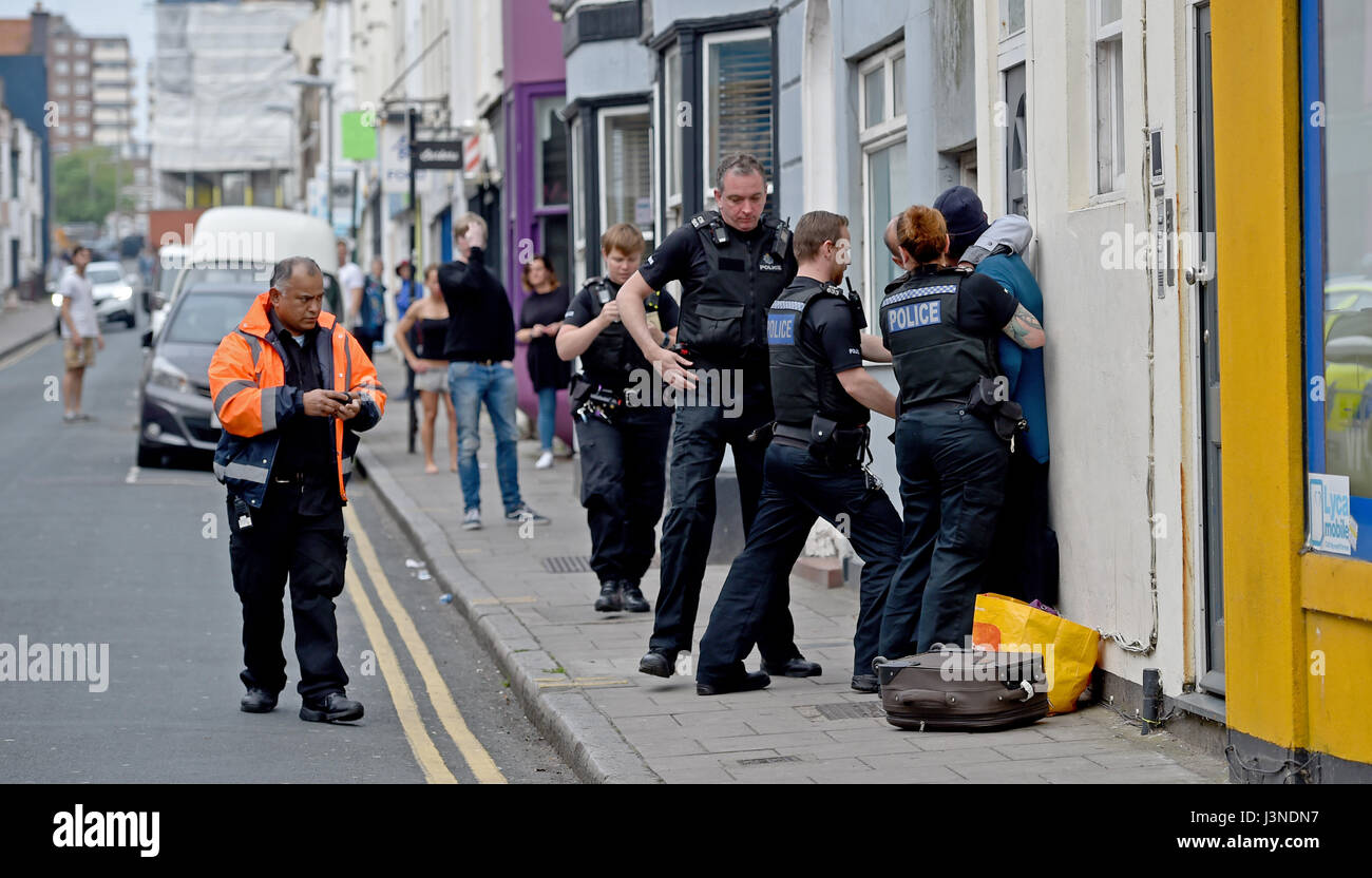 Brighton, UK. 6th May, 2017. Police arrest and lead a woman away after an incident in George Street Kemp Town Brighton this afternoon Credit: Simon Dack/Alamy Live News Stock Photo