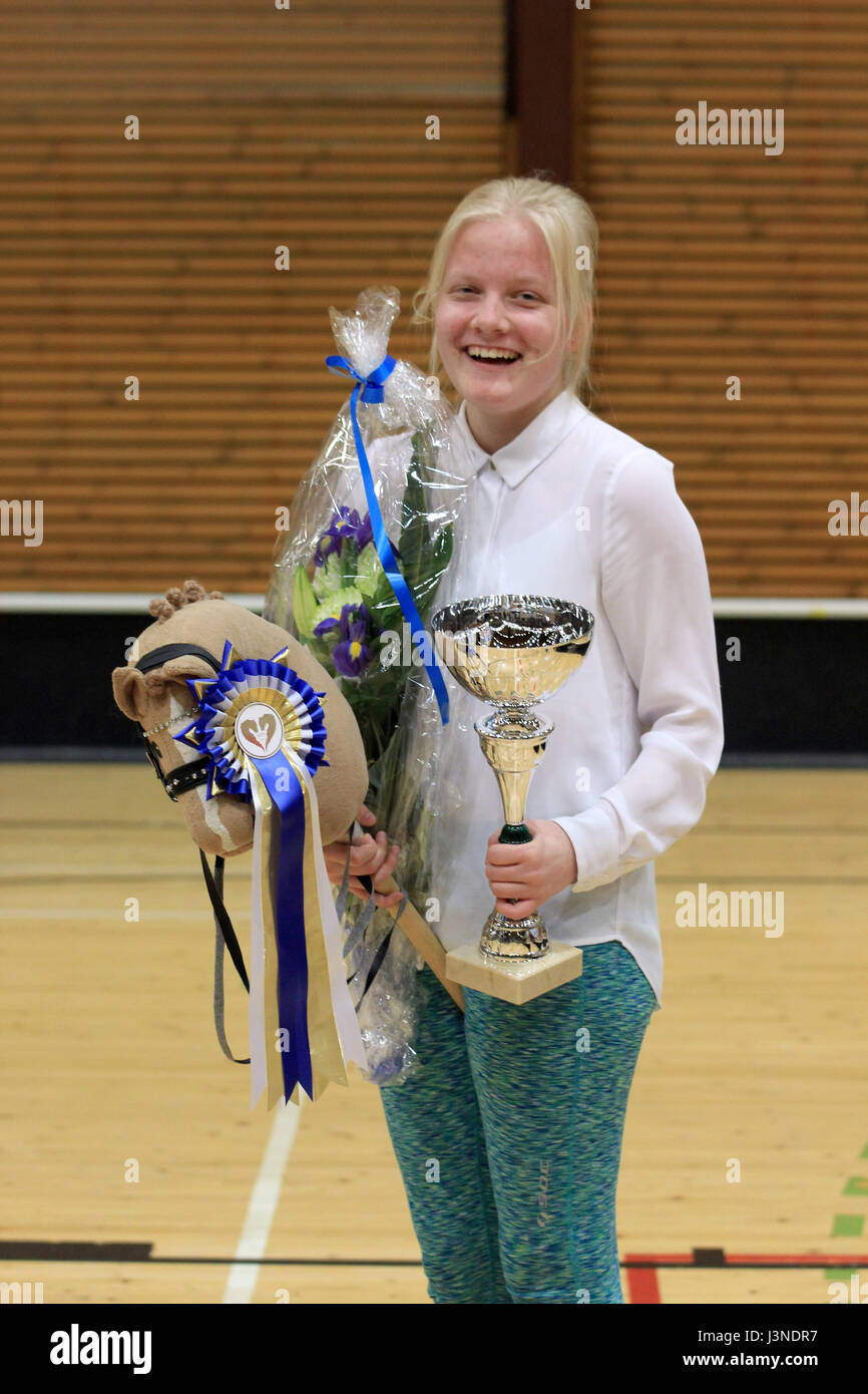 Vantaa, Finland. 29th Apr, 2017. HANDOUT - A handout picture shows 16-year old Ada Filppa from Naantali happy about having won first place in the dressage discipline at the finnish Hobby Horse Championship in Vantaa, Finland, 29 April 2017. Finland, the land of the air guitar and mobile phone throwing championships has been captured by a new phenomenon: thousands of people are hopping on horses through riding courses. Photo: Johanna Rintanen/dpa/Alamy Live News Stock Photo