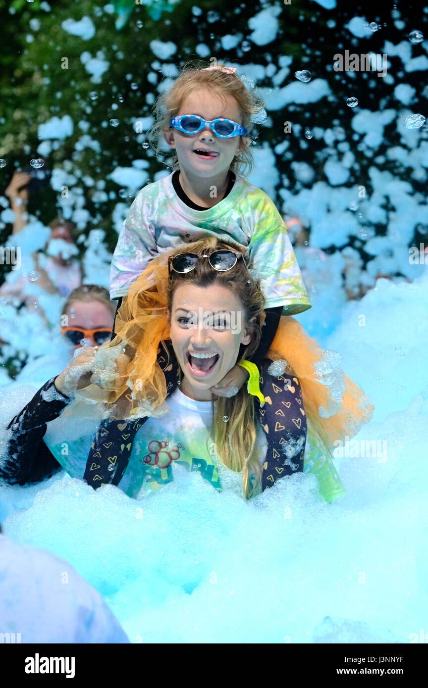 Weymouth, Dorset, UK. 7th May, 2017. Hundreds of sponsored runners take part in a the Weldmar Bubble Rush in Weymouth. The event, which involved a 4km run passing through a series of colours bubble stations where participants are covered coloured foam raised funds for the Weldmar Hospicecare Trust, Credit: Tom Corban/Alamy Live News Stock Photo