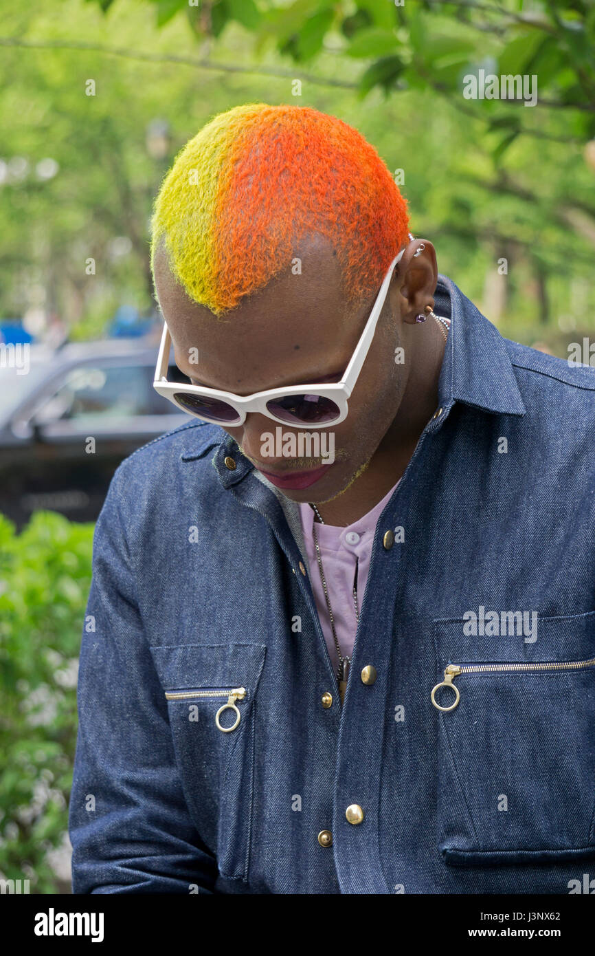 Portrait of a performance artist with two toned yellow and orange hair, In downtown Manhattan, New York City. Stock Photo
