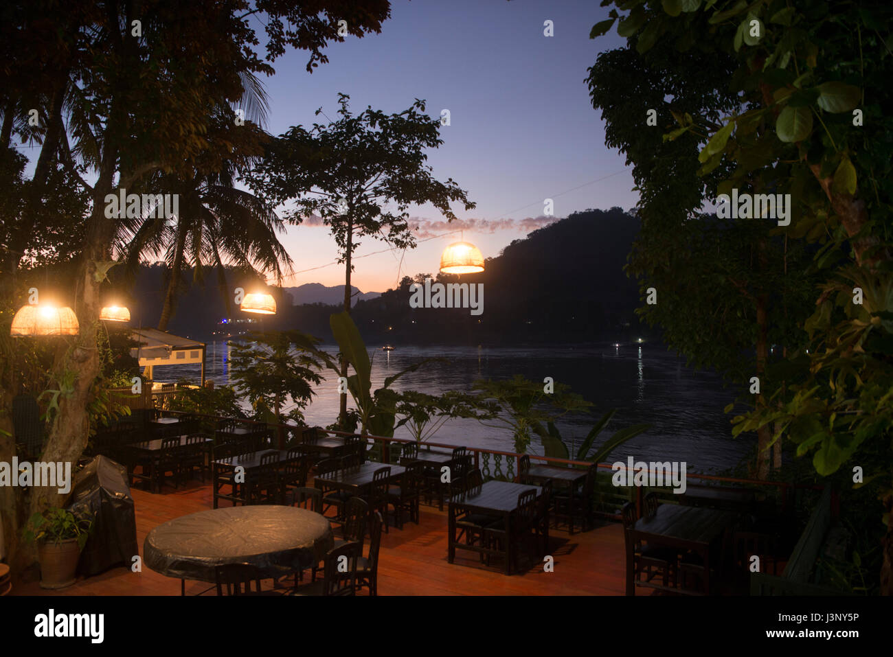 a restaurant at the Mekong River in the town of Luang Prabang in the north of Laos in Southeastasia. Stock Photo