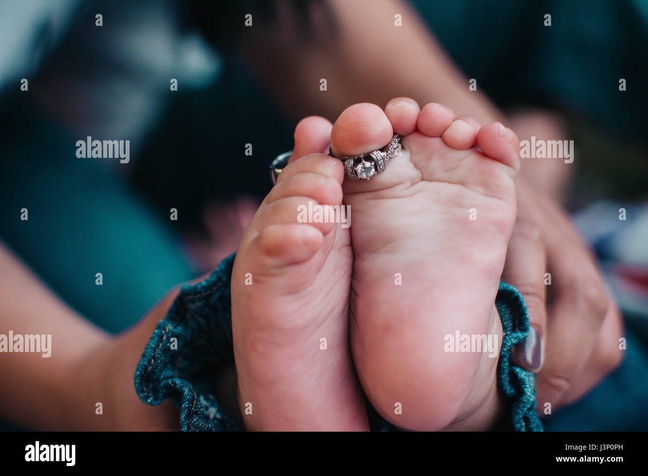 Wedding Bands on Baby Feet Stock Photo Alamy
