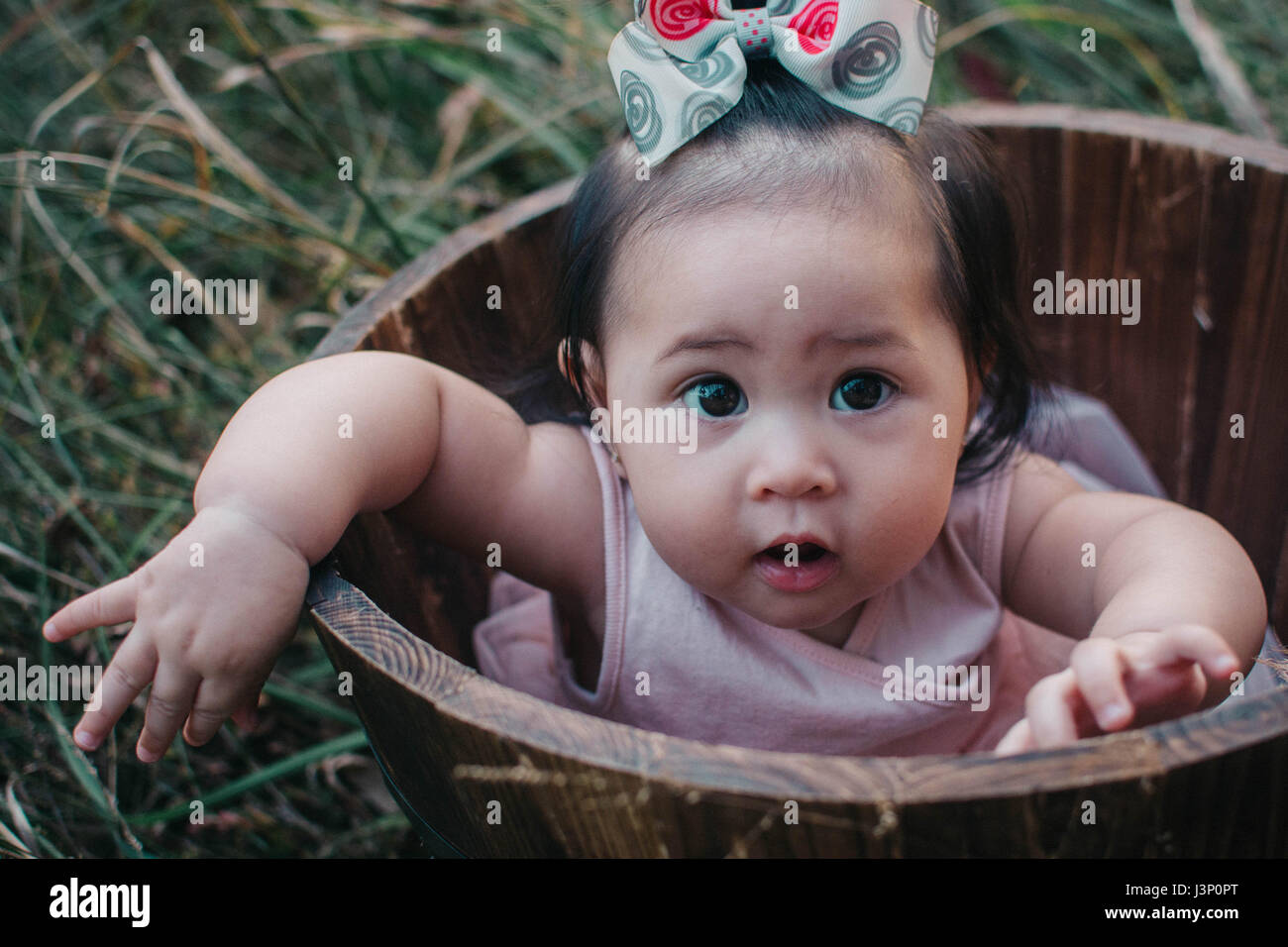 Baby in Barrel Stock Photo