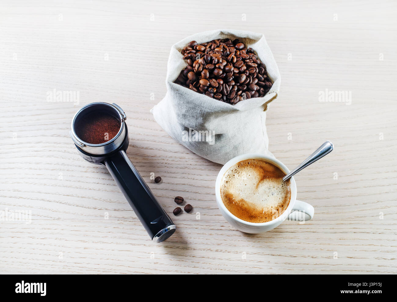Coffee cup, holder from an espresso machine and coffee beans in a