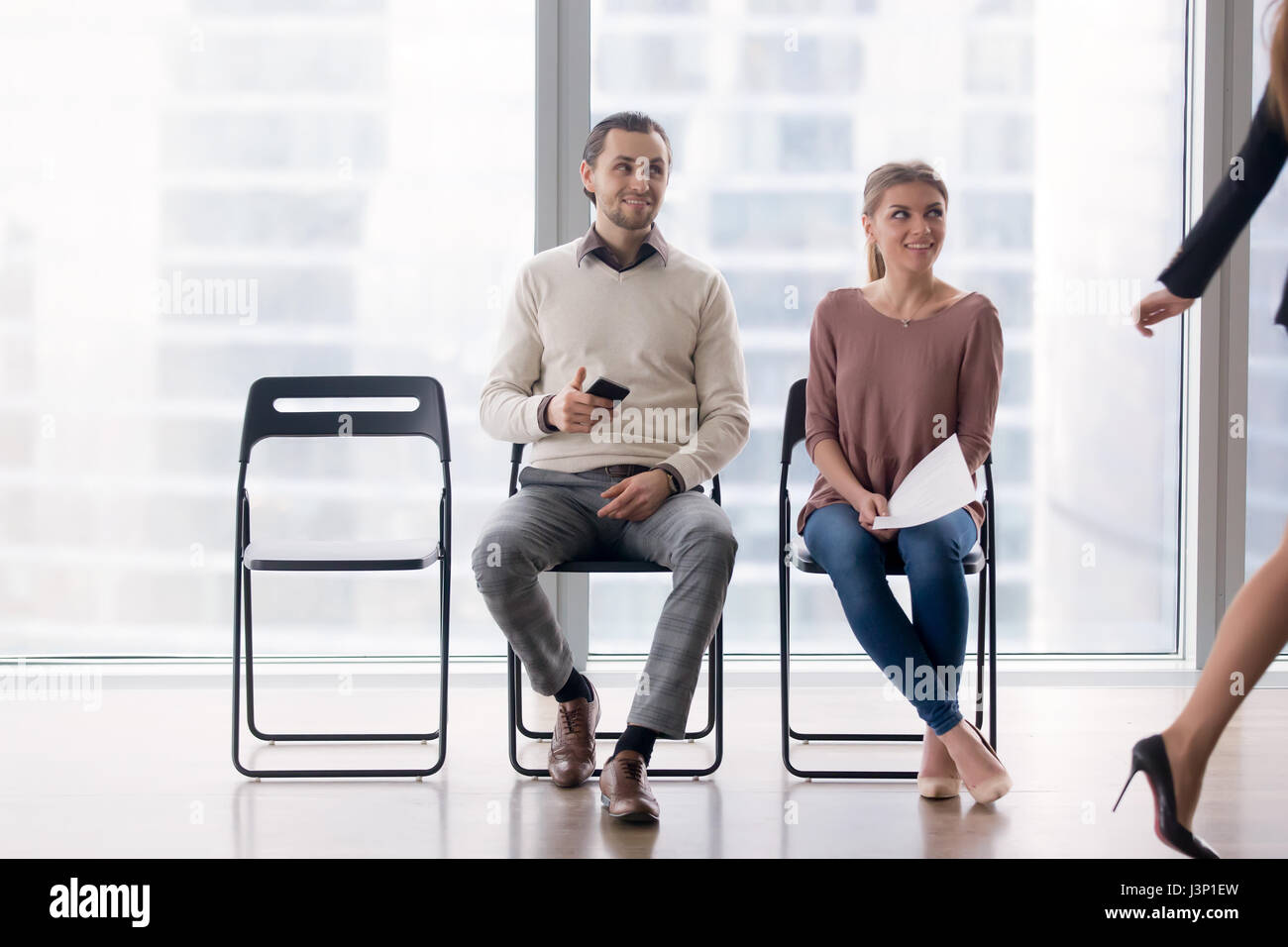 Colleagues or job applicants gazing at female coworker, fake fri Stock Photo