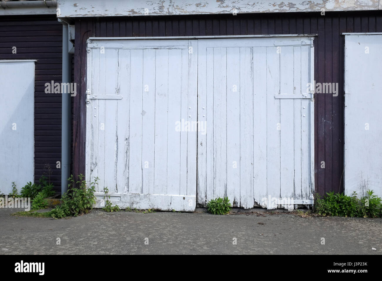 4th May 2017 - Old set of rotting wooden garage doors near the sea front in Portishead, North Somerset. Stock Photo