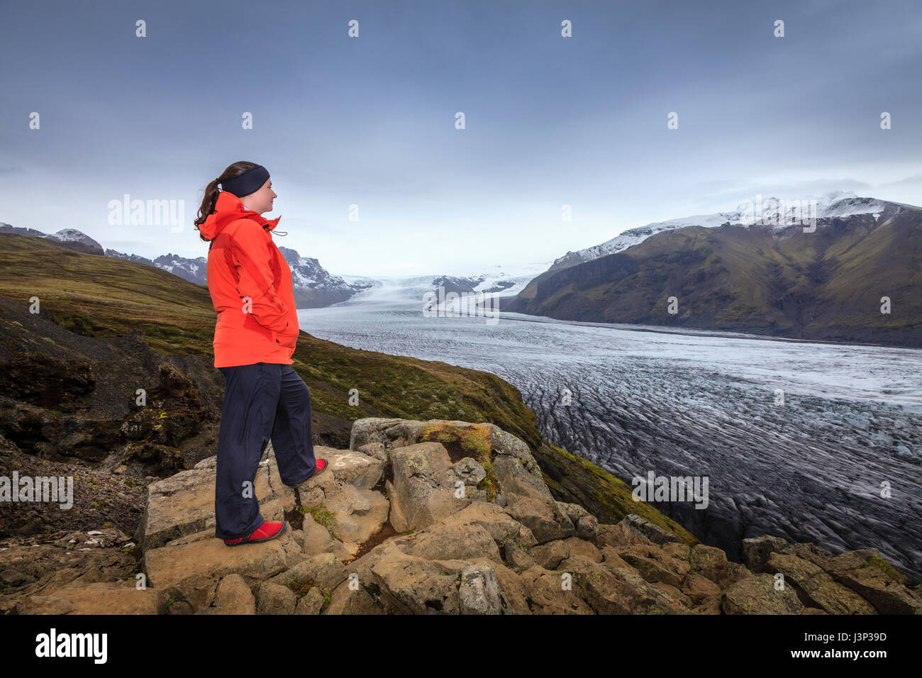 A hiker admiring view of Fjallsarlon glacier in Southern Iceland Stock Photo