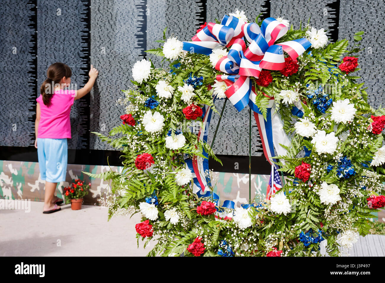 Miami Florida,Bayfront Park,The Moving Wall,Vietnam Veterans Memorial,replica,military,war,girl girls,youngster,female kids children pointing,honor,na Stock Photo