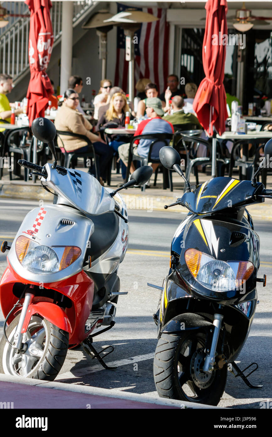 Miami Beach Florida,Ocean Drive,motor scooters,street,sidewalk cafe,diners,al fresco sidewalk