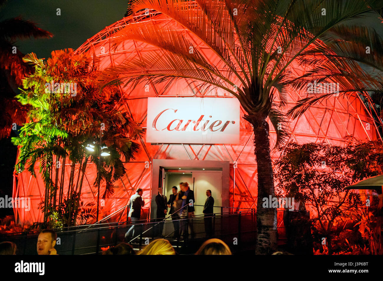 Miami Beach Florida,Art Basel,Miami Beach,Botanical Gardens,Cartier,geodesic dome,David Lynch exhibit,red,lit,light,palm tree,silhouette,event venue,a Stock Photo