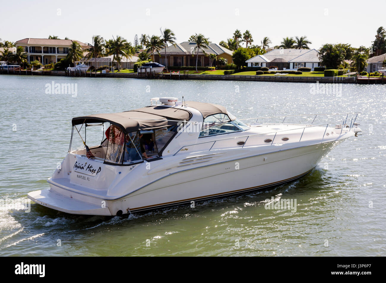 Naples Florida,Moorings Bay water,waterfront,houses,pleasure boat,cabin cruiser,boating,boat,yacht,leisure,recreation,watercraft,visitors travel trave Stock Photo