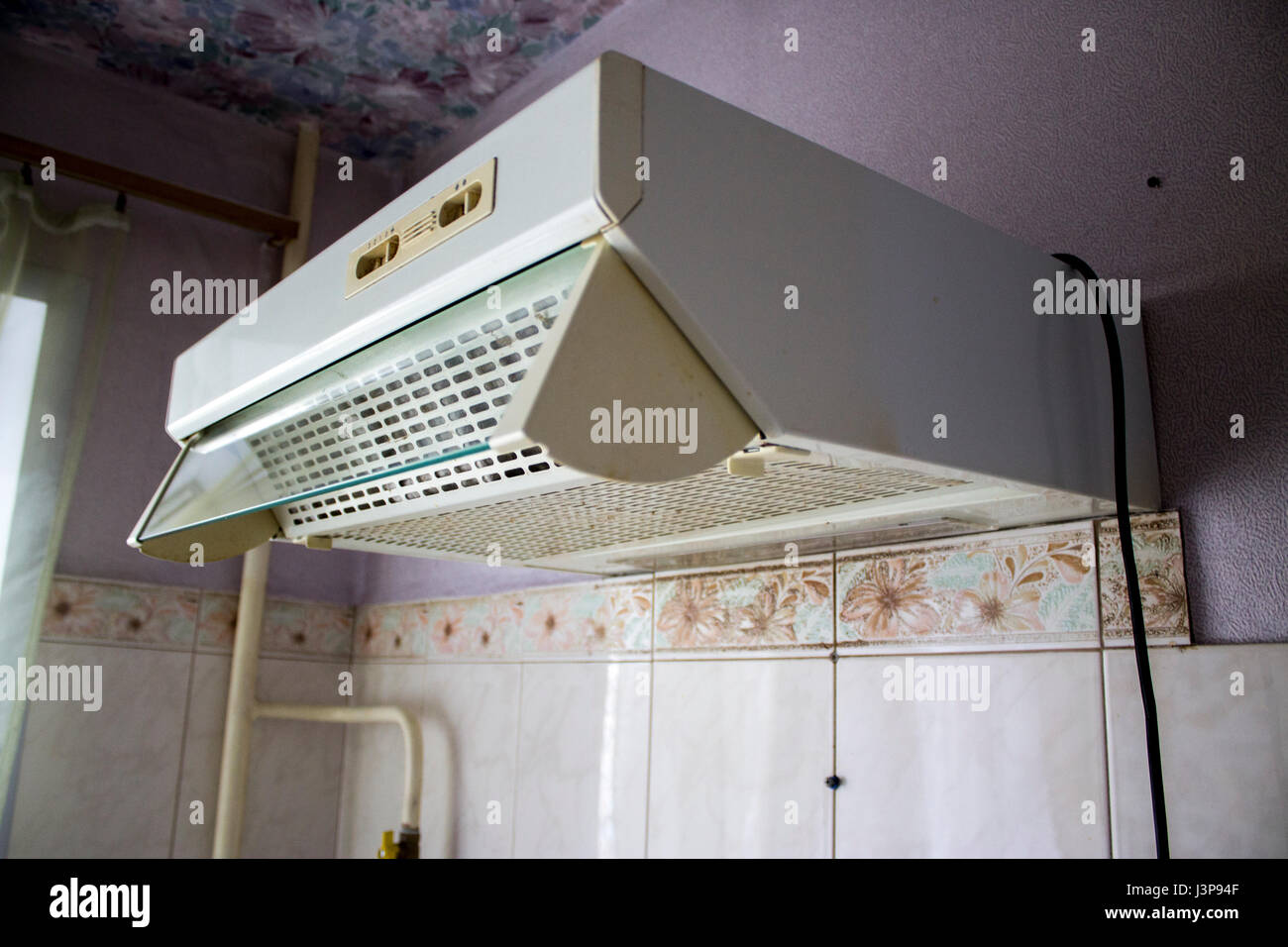 Old cooker hood in the kitchen with poor repair Stock Photo - Alamy