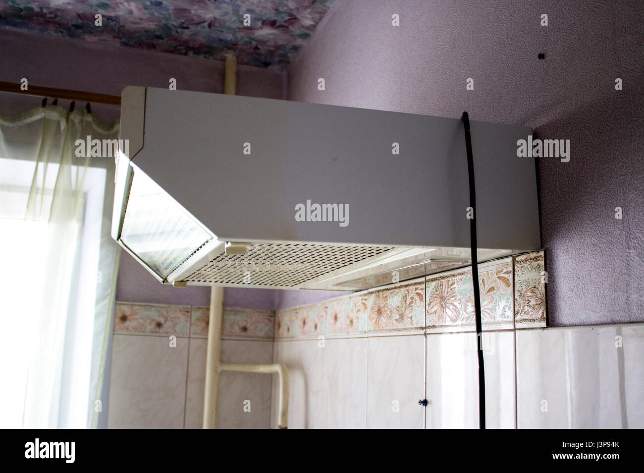 Old cooker hood in the kitchen with poor repair Stock Photo - Alamy