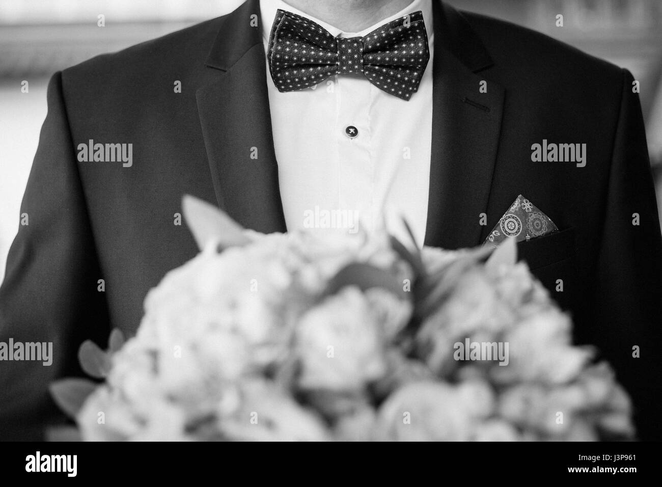 Grooms morning preparation. Handsome groom getting dressed and preparing for the wedding Stock Photo