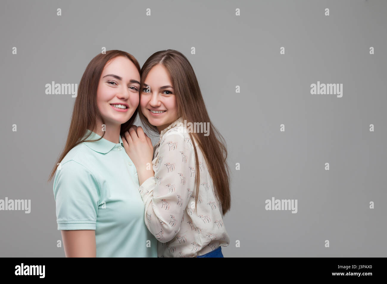 Two women hugs together, studio photo shoot. Female friendship Stock Photo