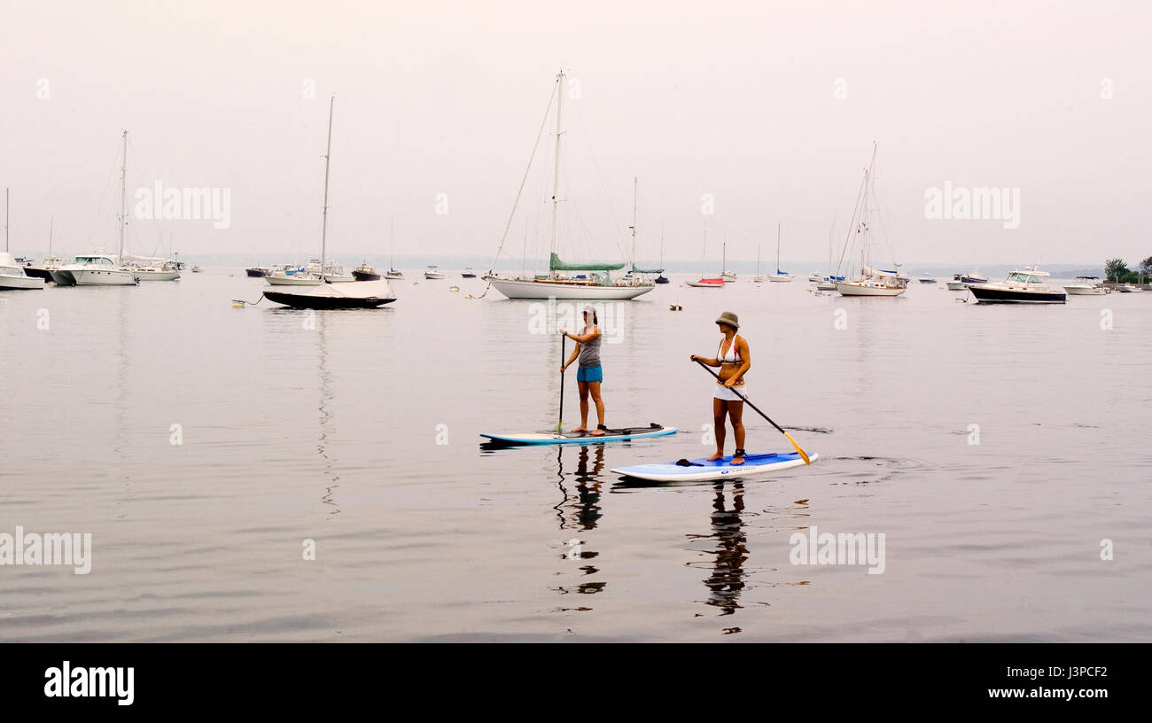 Paddleboarding across the harbor in Watch Hill, Rhode Island, USA Stock Photo