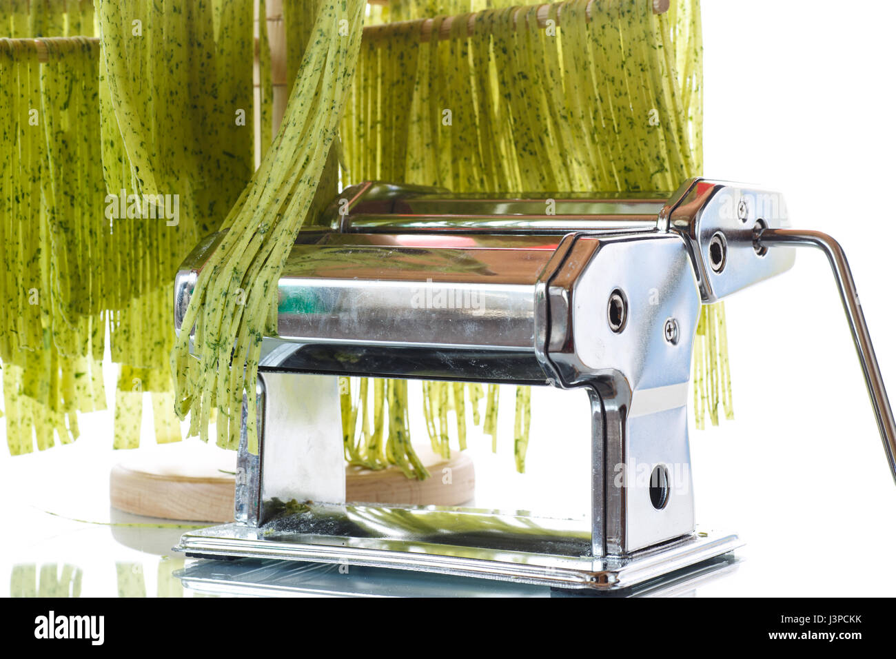 Homemade noodles green with greens on a white background Stock Photo