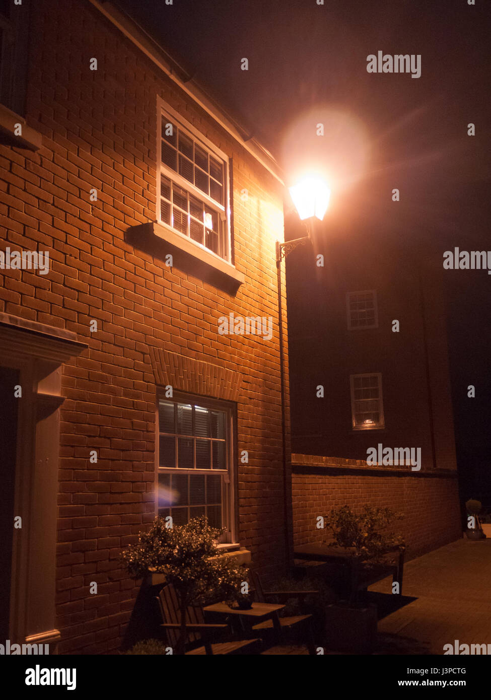 street light outside during the night near house Stock Photo Alamy