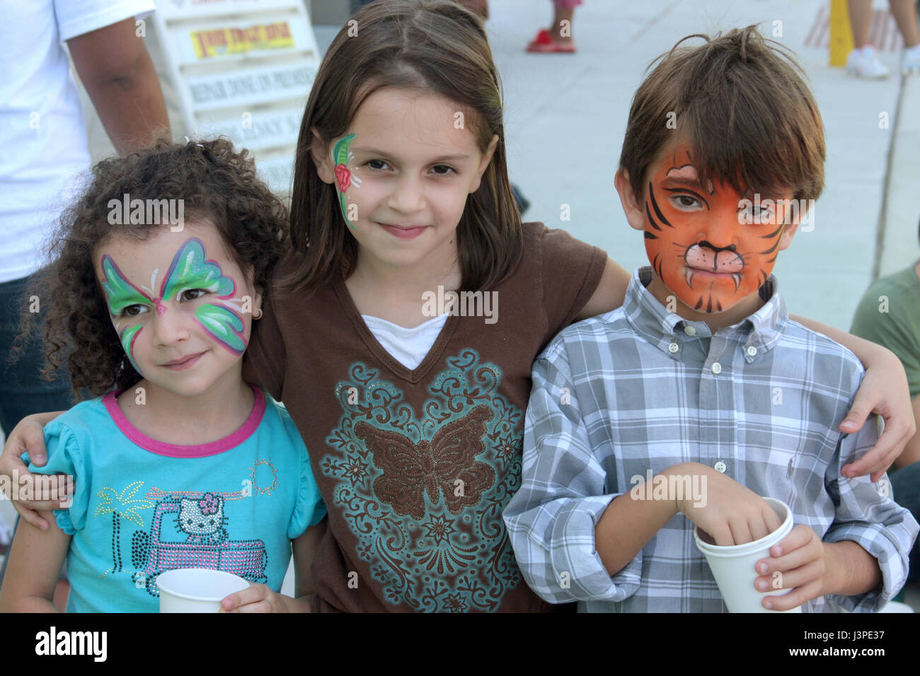 Three little kids with face paint at party Stock Photo Alamy