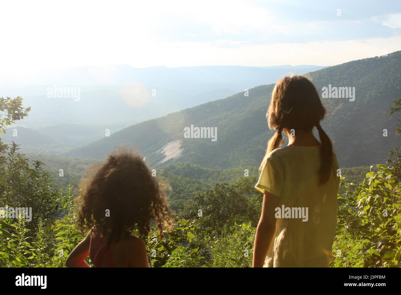 Two little girls in front of mountain landscape in summertime Stock ...