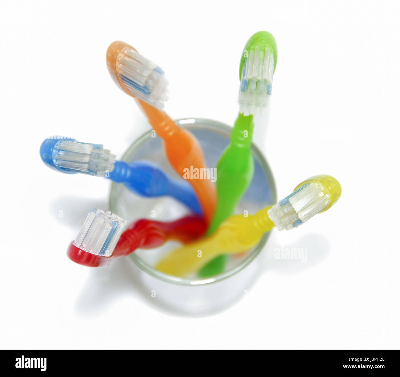 colorful toothbrushes in grass on withe background Stock Photo - Alamy