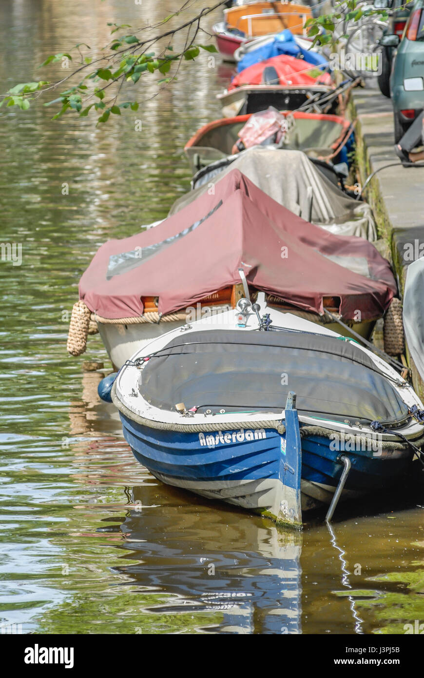 Small Boats named Amsterdam in a water channel in the inner city of