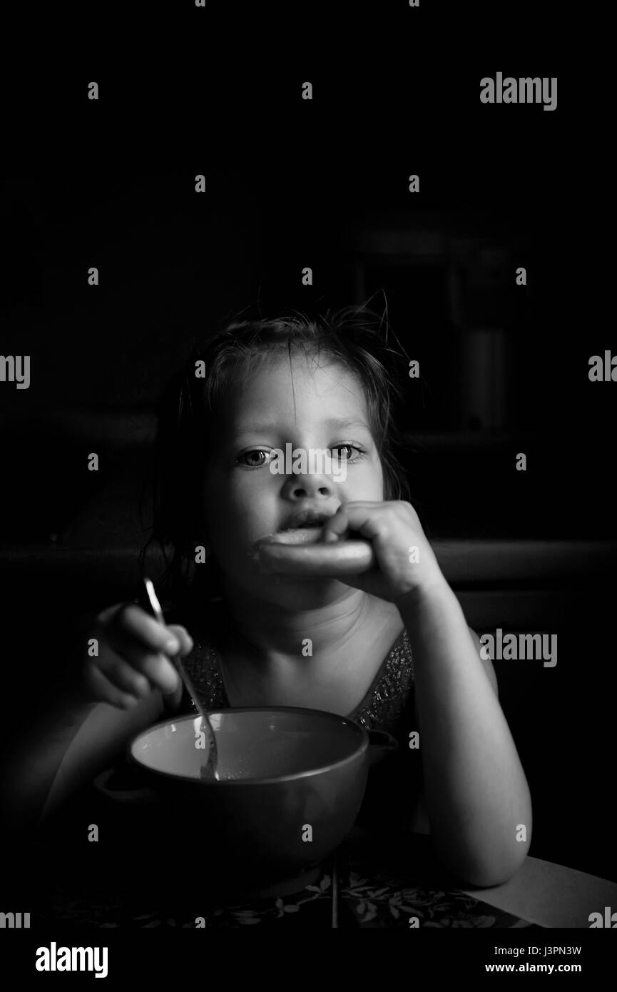 The girl eats soup with the wheel.Appetite Stock Photo