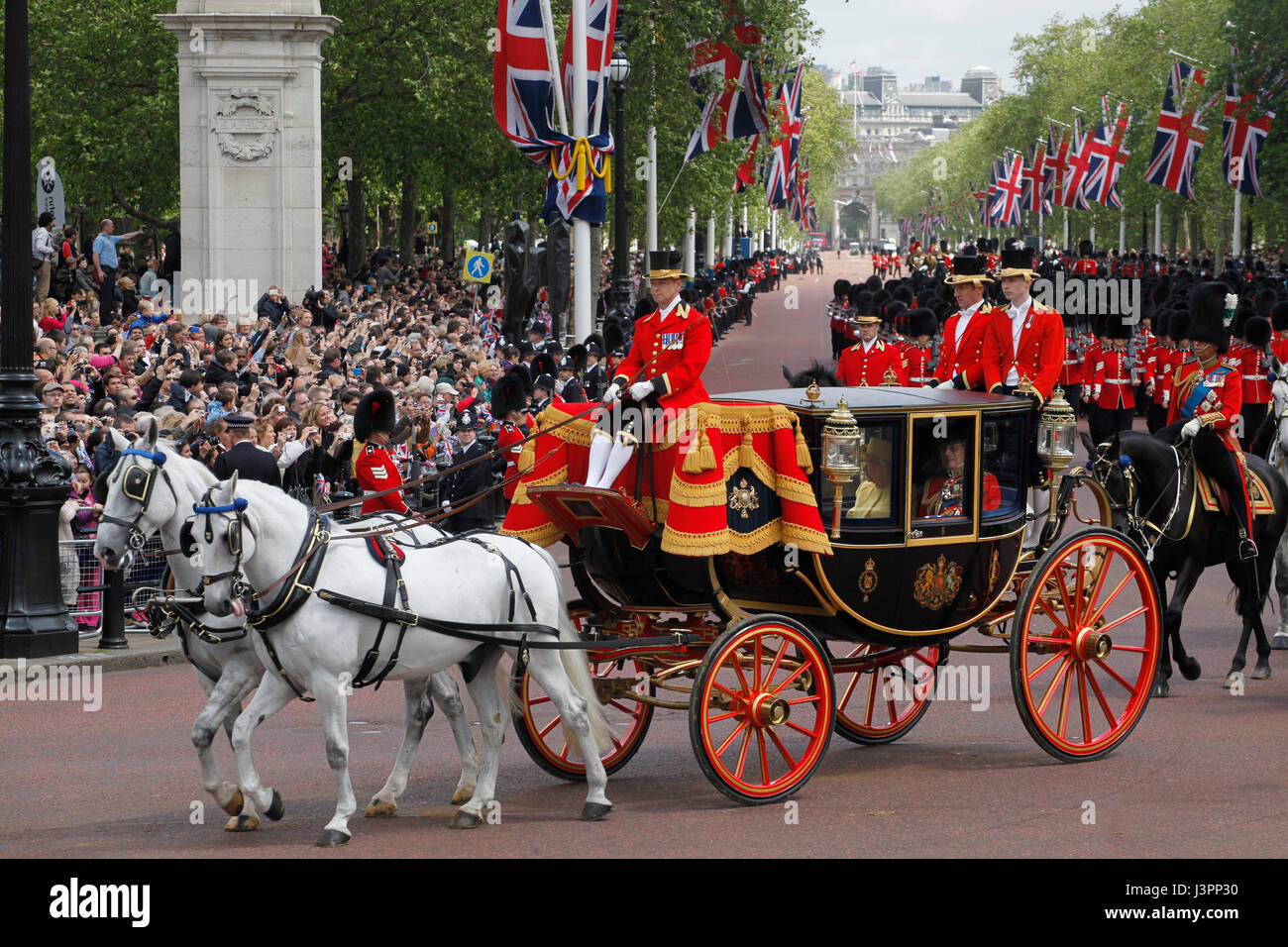 Procession with Royal Carriage and Queen Elizabeth II and Prince Philip return to Buckingham Palace from Ceremony of Trooping the Colour June Stock Photo