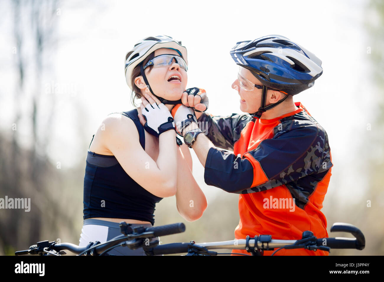 Athletes wear helmets in park Stock Photo Alamy