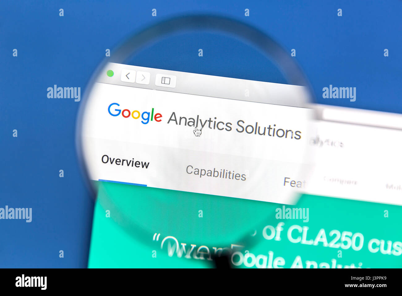 Google Analytics website under a magnifying glass. Google Analytics is a web analytics service