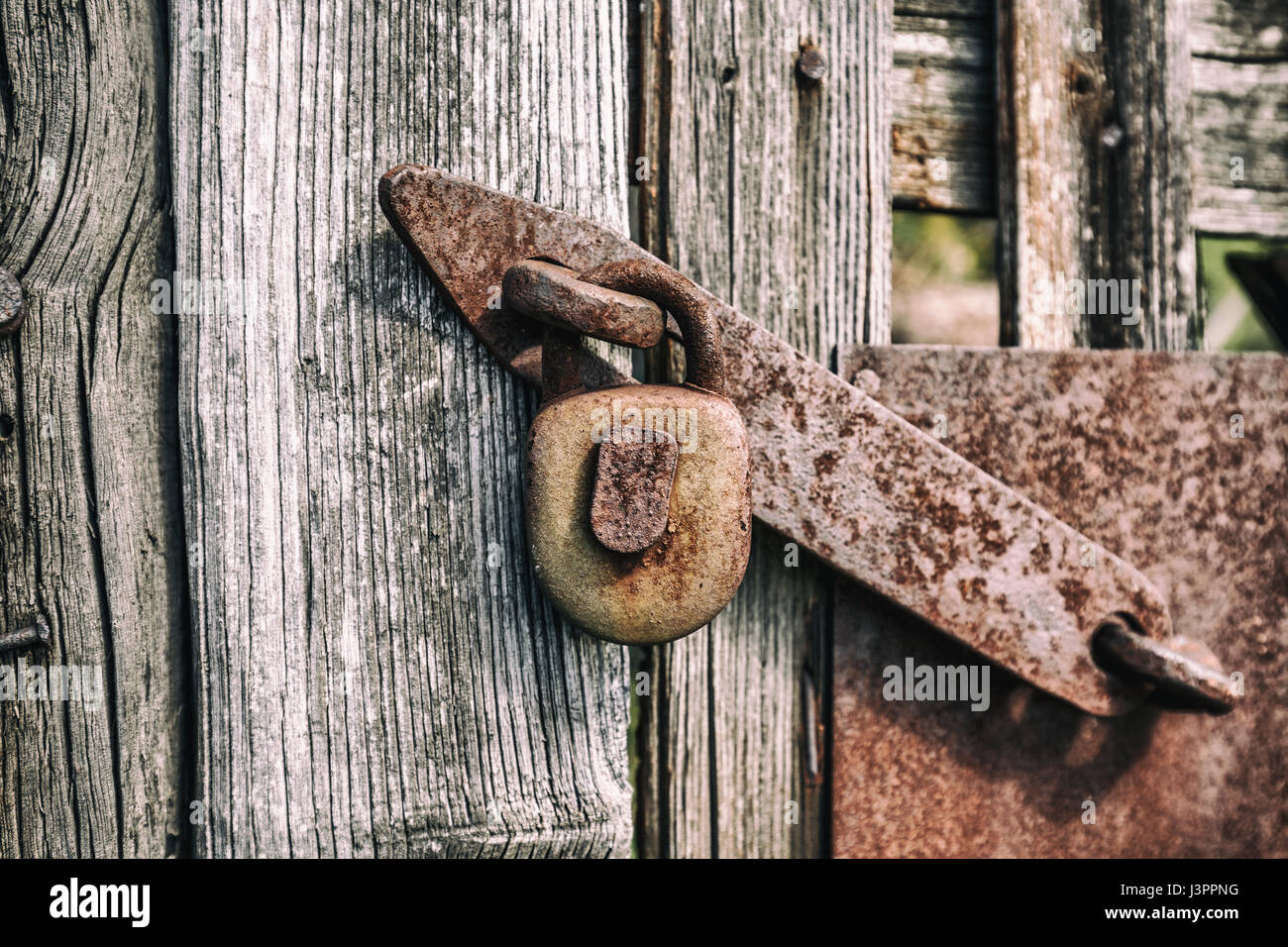 Old rusty metal padlock hanging on the wooden textured door Stock Photo ...