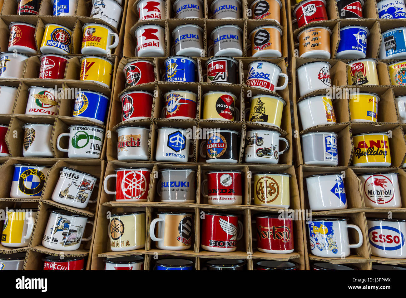 STUTTGART, GERMANY - MARCH 03, 2017: Souvenir mugs with logos of famous automotive brands, oil companies and beverage producers. Europe's greatest classic car exhibition 'RETRO CLASSICS' Stock Photo