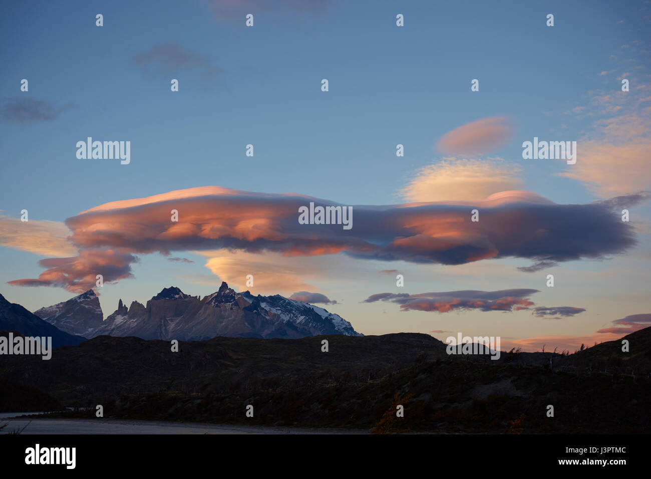 Lenticular clouds at dusk over the mountains of Torres del Paine National Park in Patagonia, Chile Stock Photo