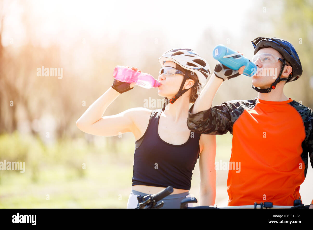 Cyclists drink water from bottle Stock Photo