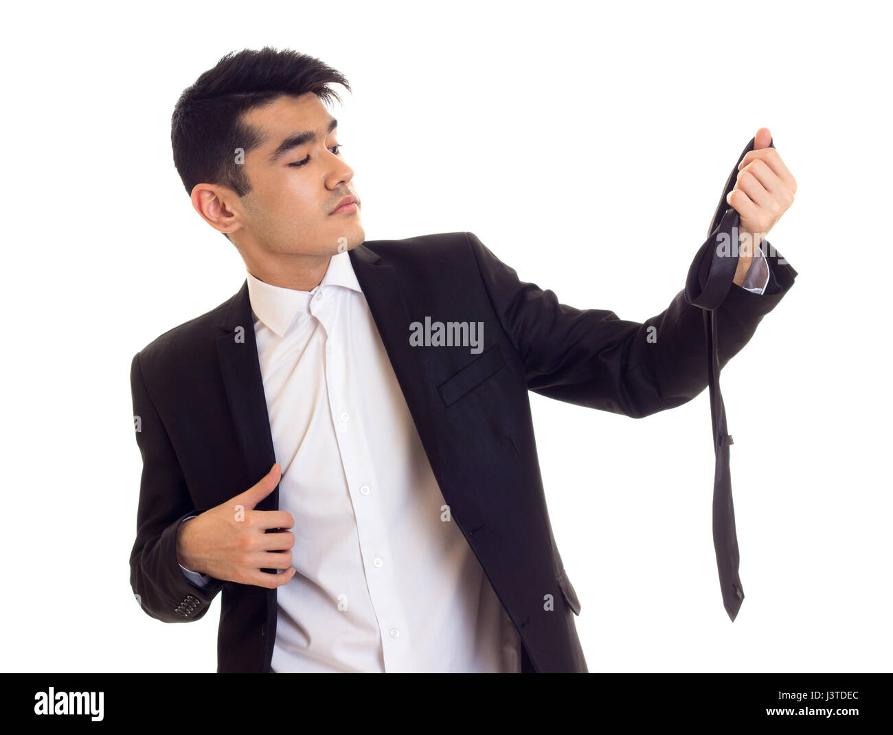 Young man in suit fixing his tie Stock Photo - Alamy