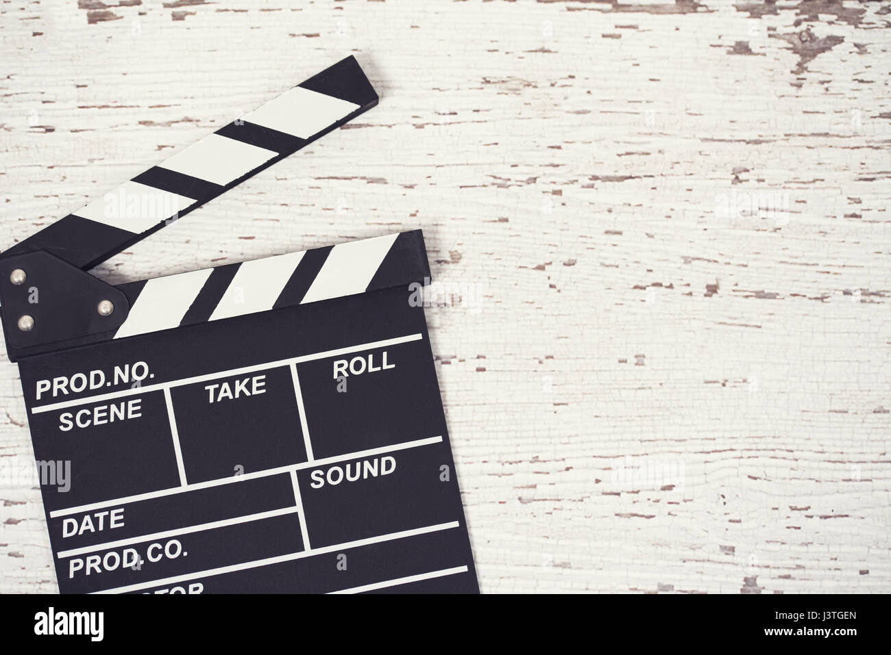 Screenwriter desktop with movie clapper board wooden background top view Stock Photo