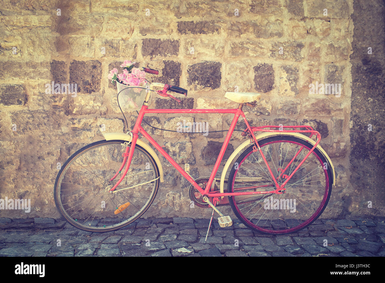 Old retro bicycle against brick wall Stock Photo