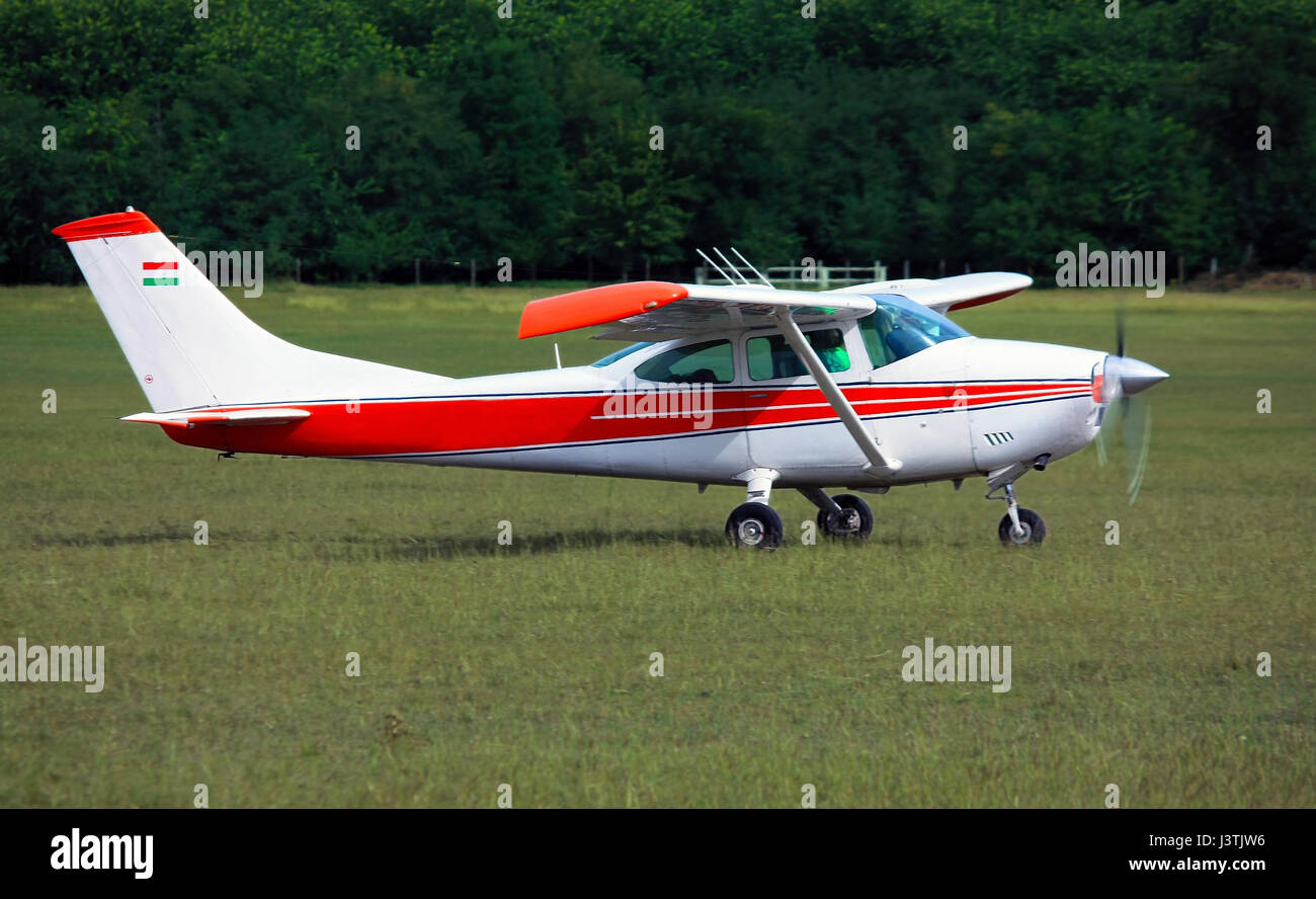 Light red white school airplane on airport grass before take off Stock Photo