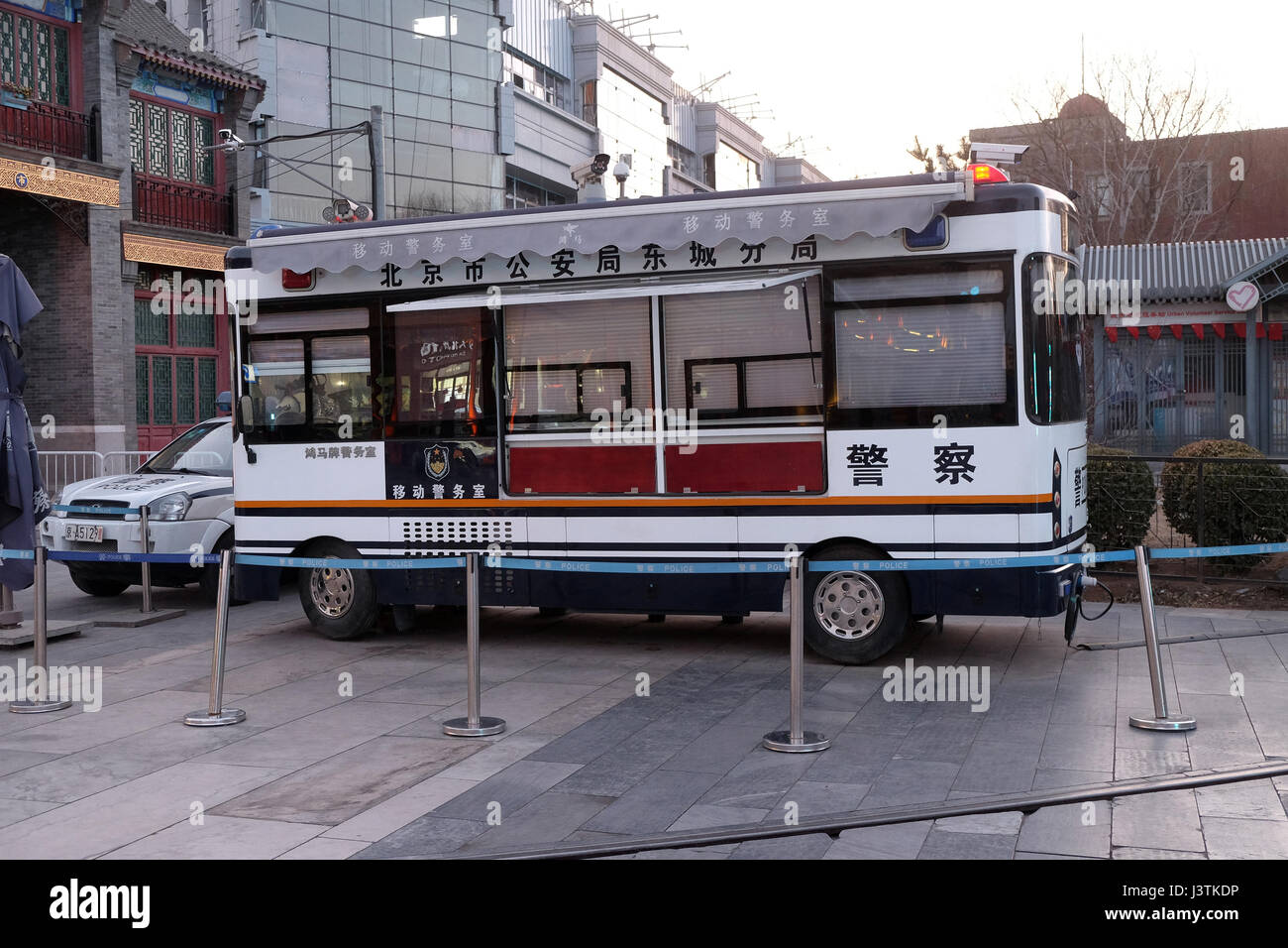 Chinese police bus on a walking street at a shopping square in Beijing, China, February 22, 2016. Stock Photo