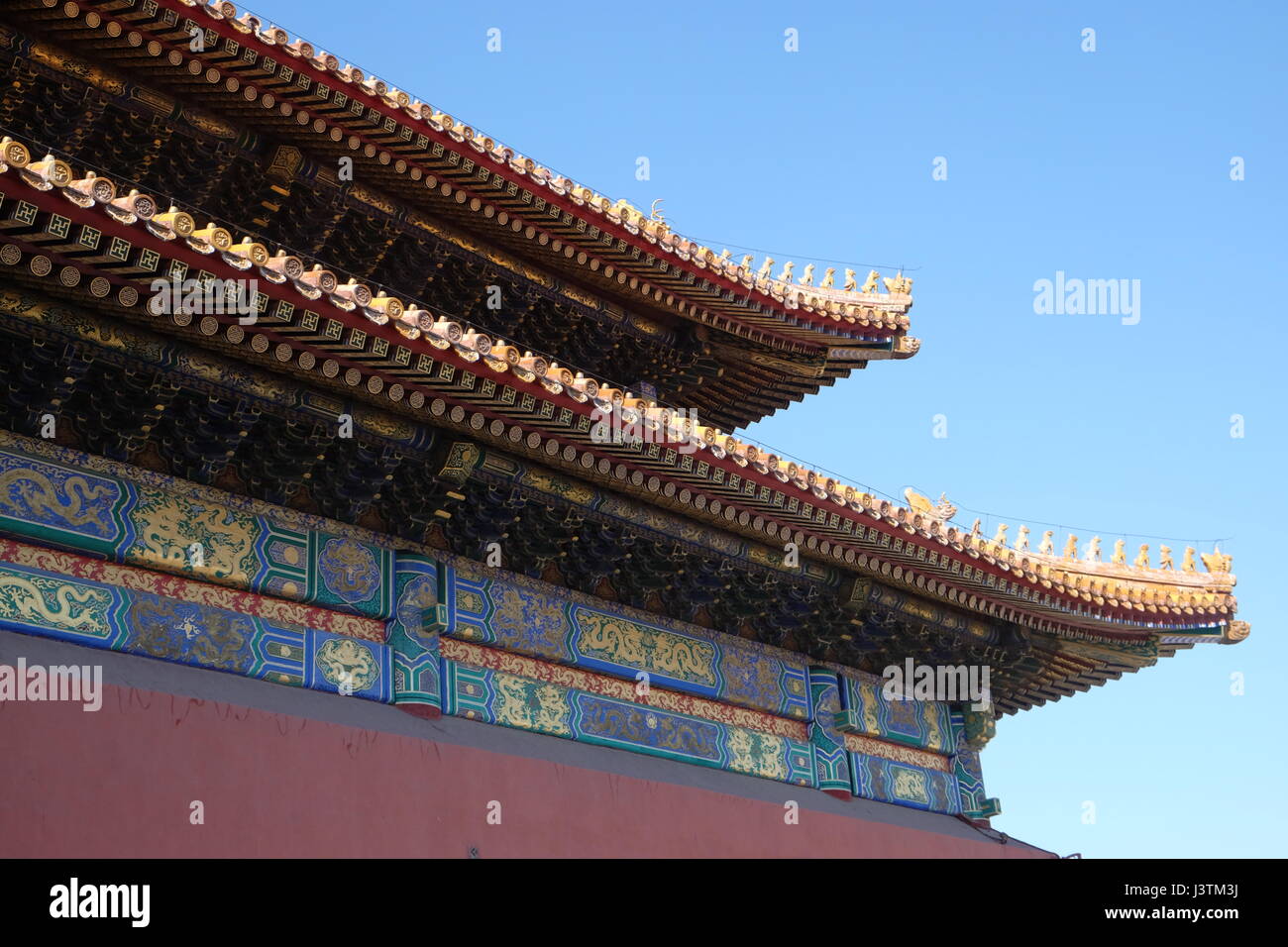 Tiled roof and facade decorated with a Chinese pattern. Palace in The Forbidden City, Beijing, China, February 23, 2016. Stock Photo