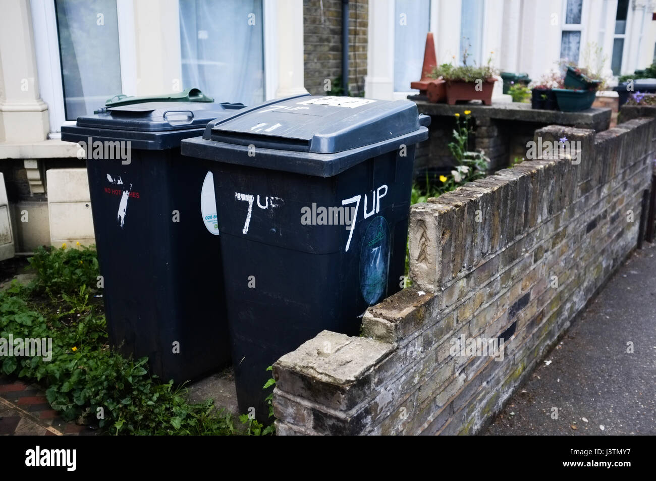 '7up' written on black wheelie bin, placed outside Victorian terraced