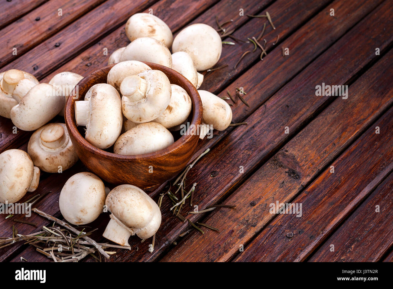 Mushrooms champignon on wooden background. Copy space. Stock Photo